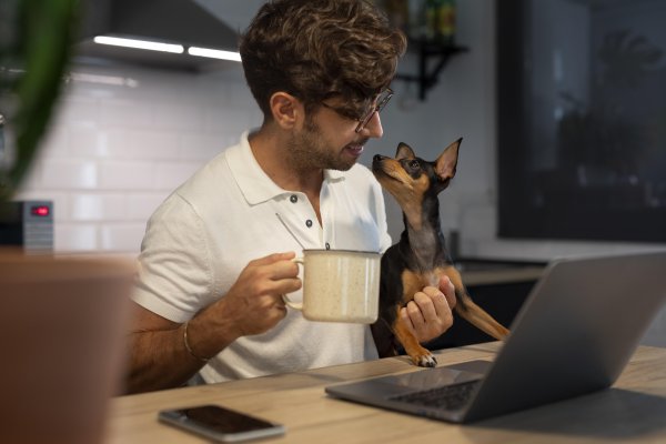 person-working-from-home-with-pet-dog